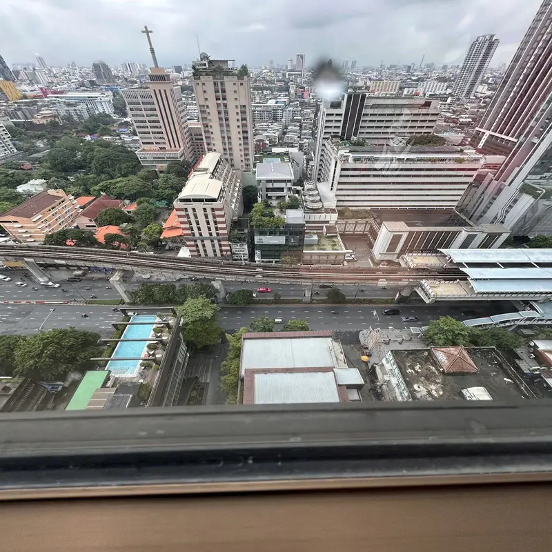 The Bangkok skyline at dusk from a high hotel floor